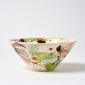 A photo of a hand thrown and decorated ceramic bowl. This small bowl features a hand painted floral design.