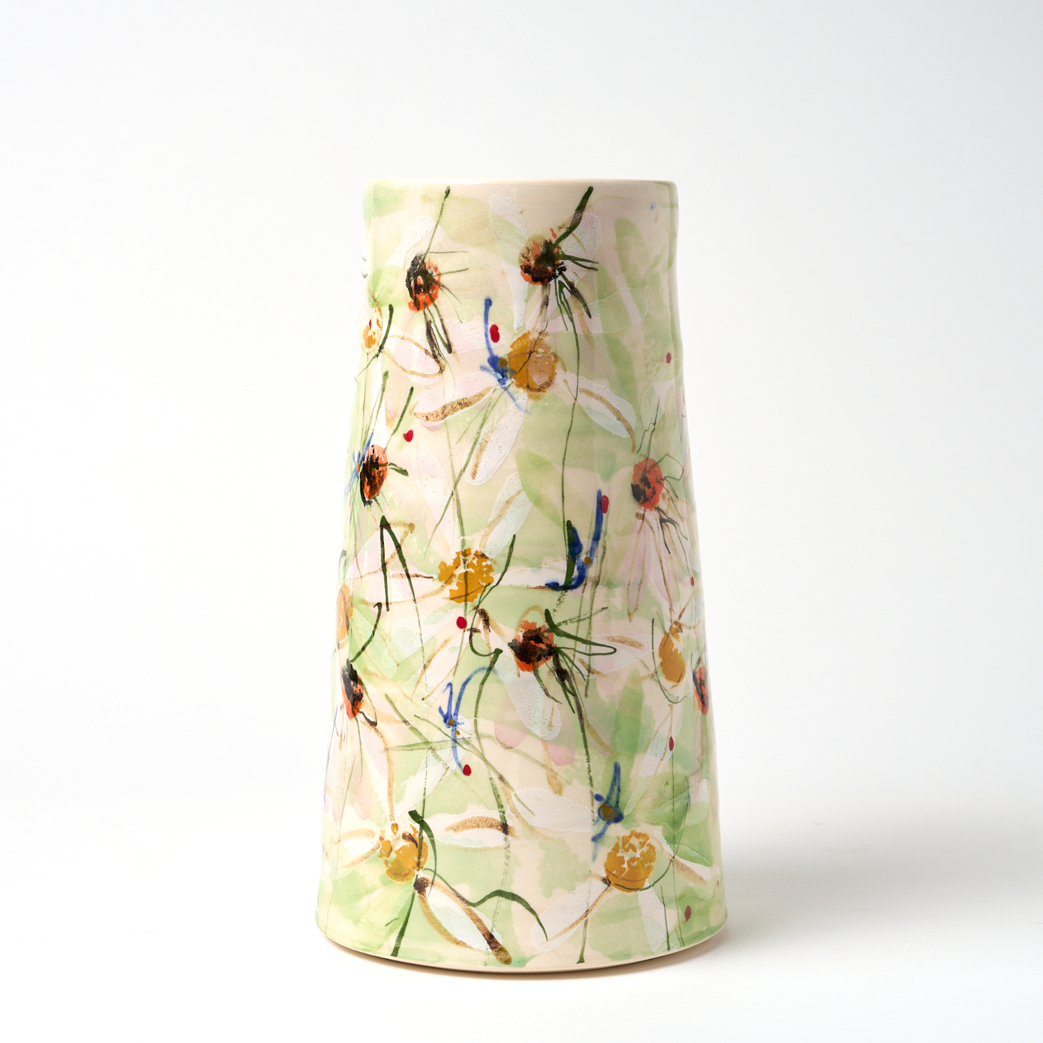 A photo of a ceramic vase with a hand painted floral design.